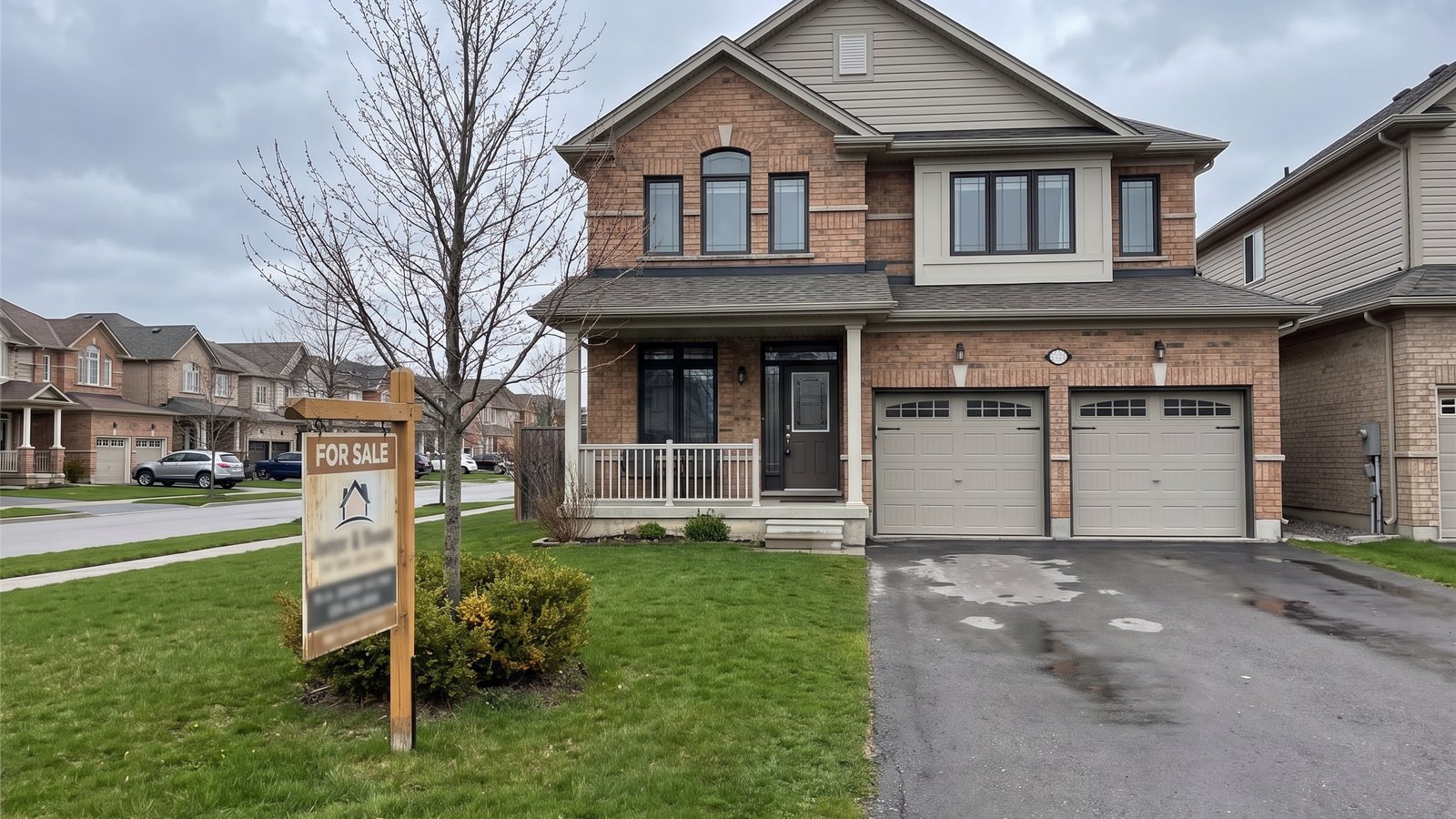 A For Sale sign on the lawn of a home in the GTA
