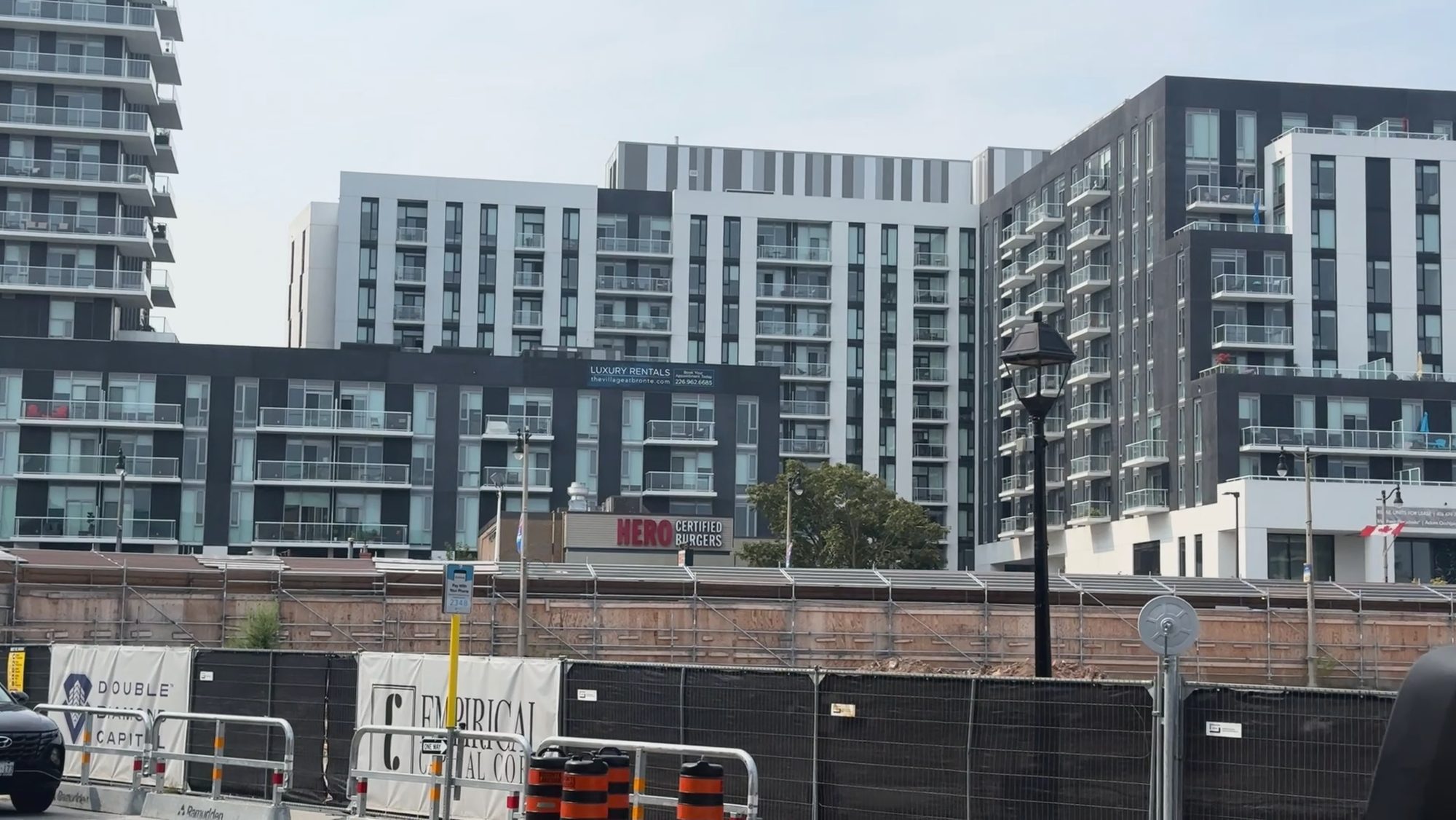Mid-rise apartment buildings in pale cladding along a city street
