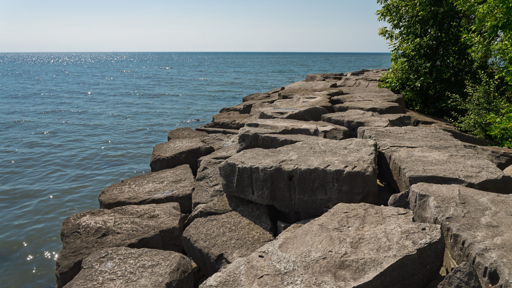 The armour-stone breakwater at Port Credit reaching out into Lake Ontario on a clear day