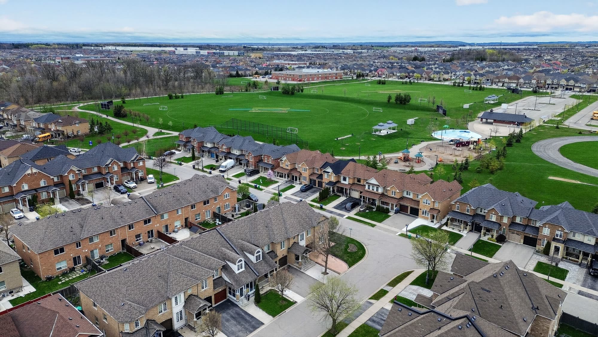 Aerial view over Sandringham-Wellington in northeast Brampton, showing the townhouse and detached streets around the neighbourhood park